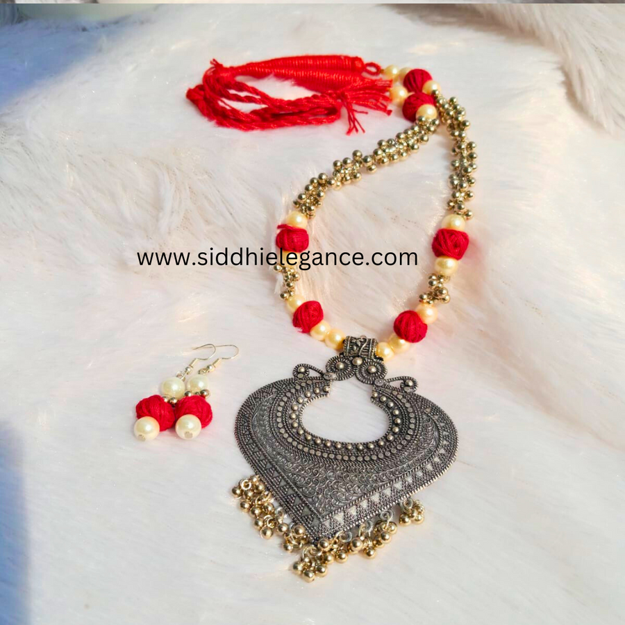 Oxidised pendant red cotton bead necklace